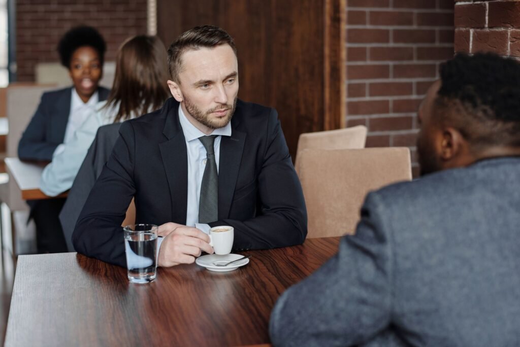 Two adults in calm conversation at a small cafe table