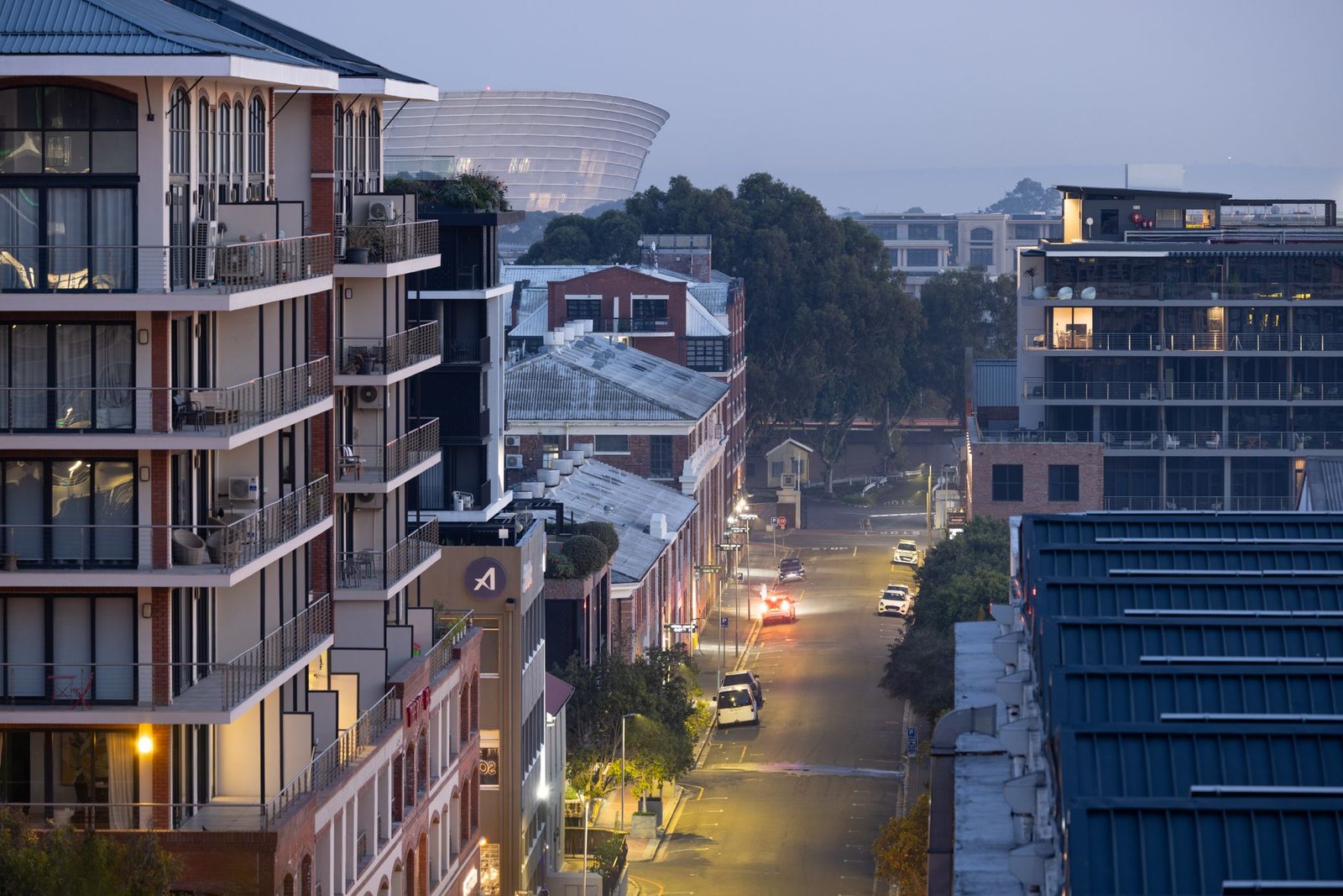 Quiet residential street in Lagos at dusk with warm streetlights