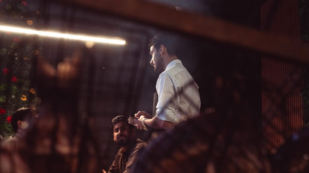 Two adults talking at an outdoor table in the early evening