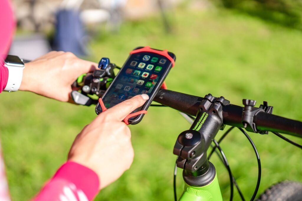 Smartphone with a ride-hailing app beside keys on a table in a dim lounge