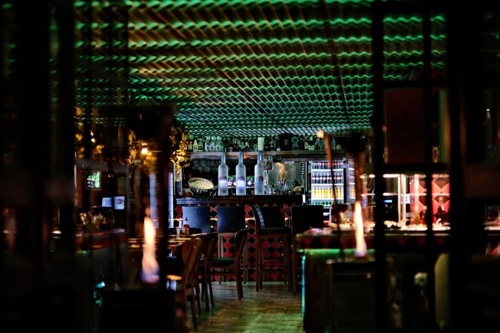 Simple Nigerian restaurant interior with warm evening lighting and a drink on the table