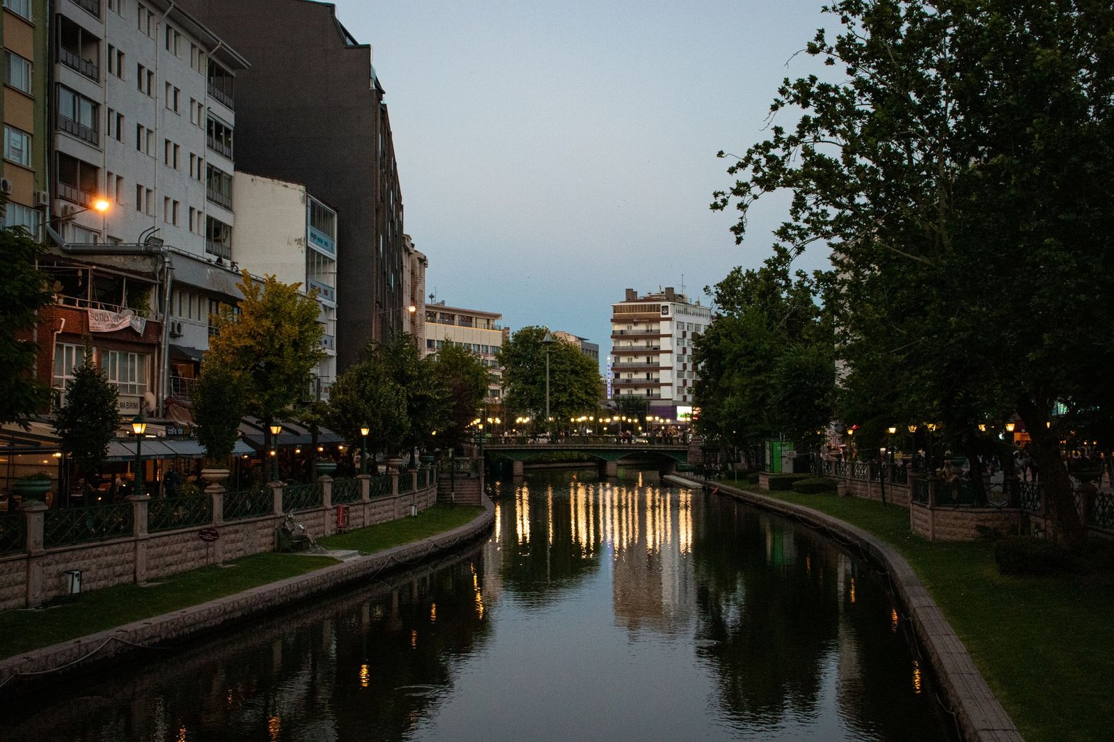 Quiet riverside street in a small West African town at dusk