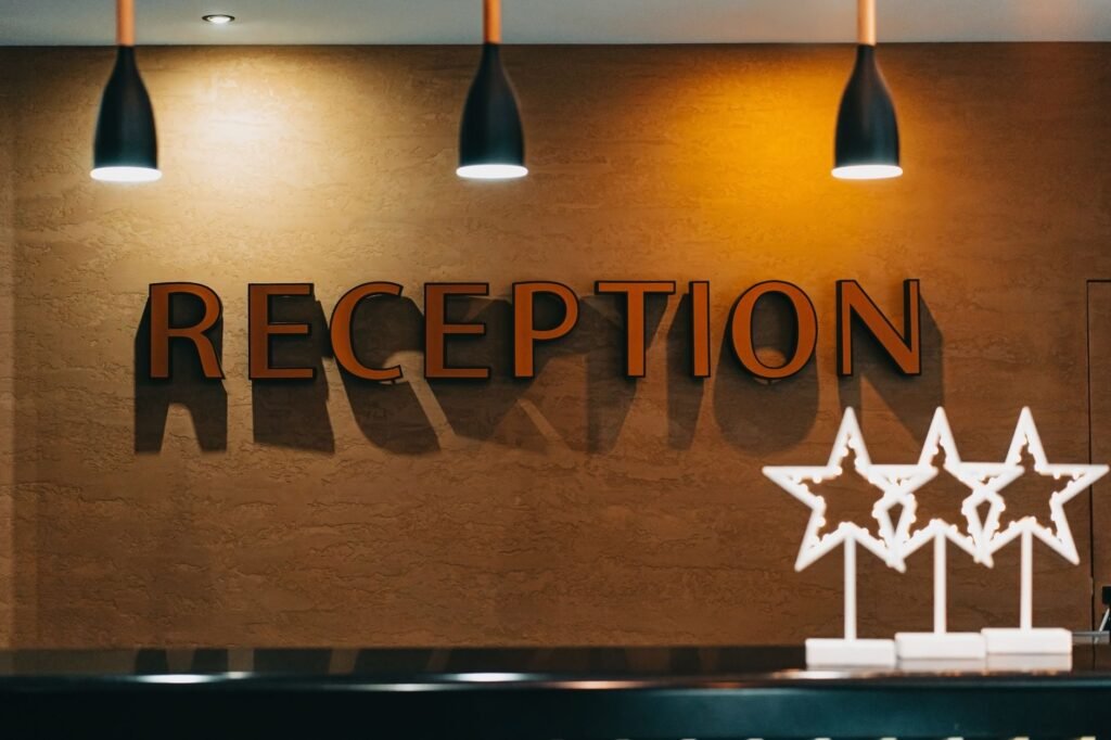 Simple guest house reception area with a wooden counter