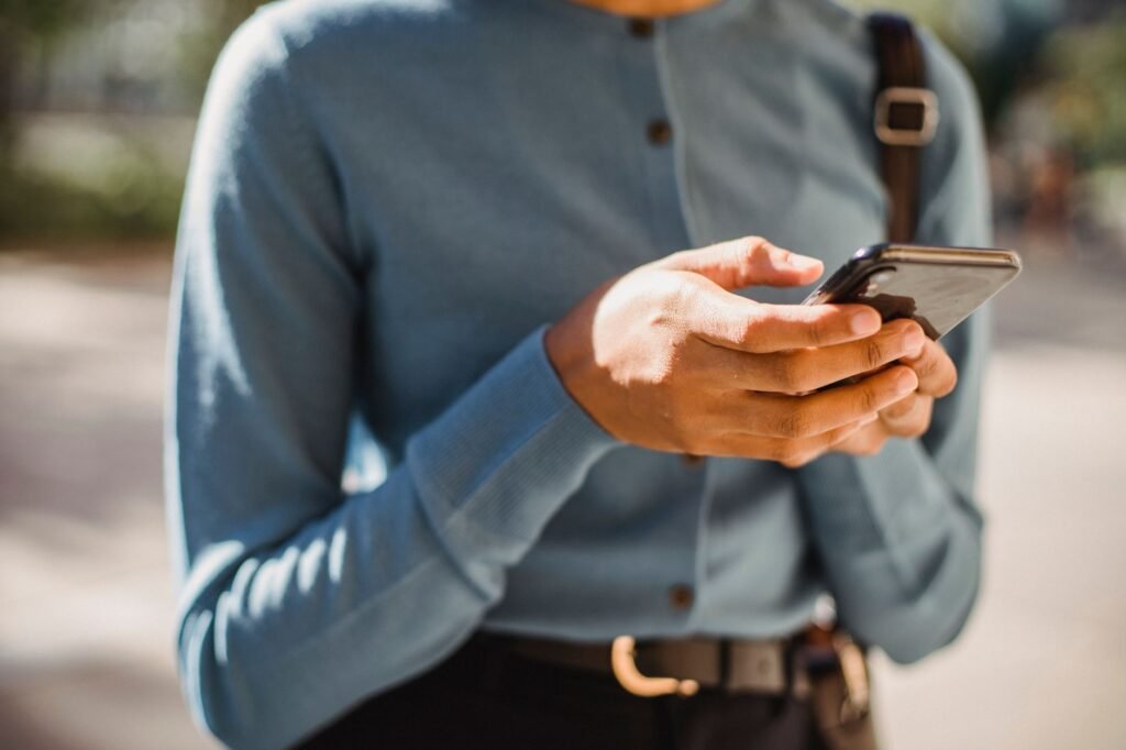 Close-up of hands composing a message on a smartphone