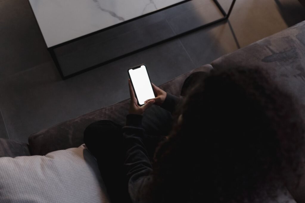 A person reading a listing on their smartphone in a calmly lit room