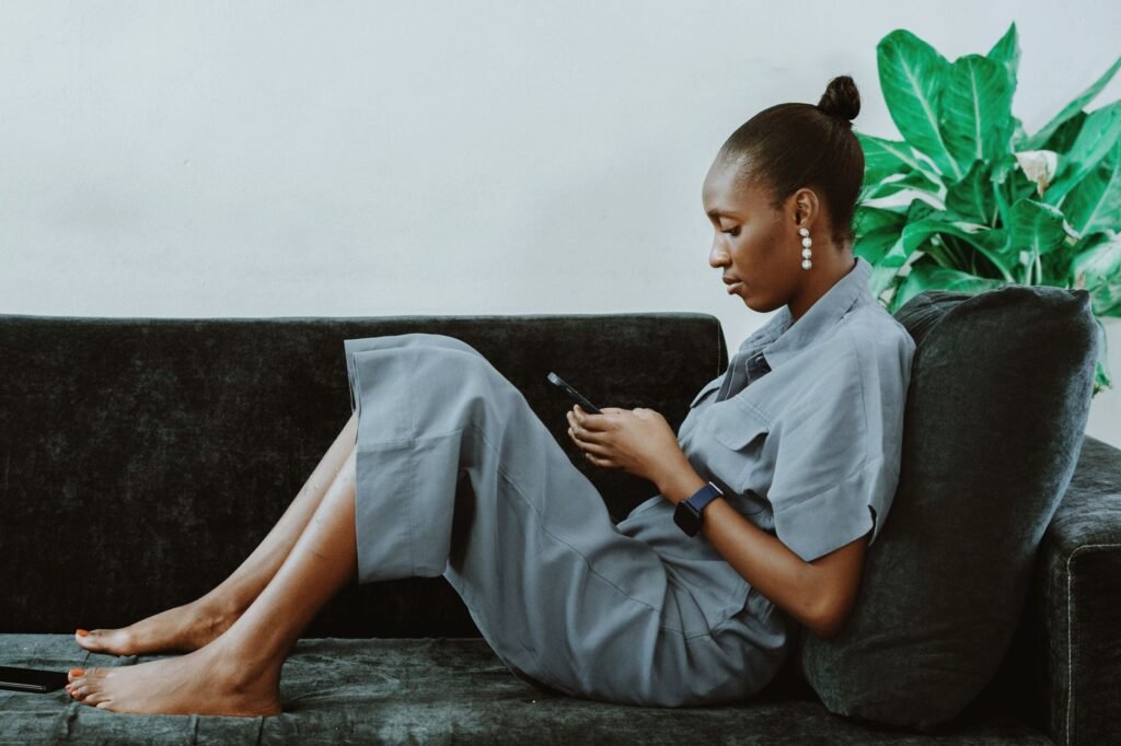 Person calmly reading a profile on a smartphone at a table indoors