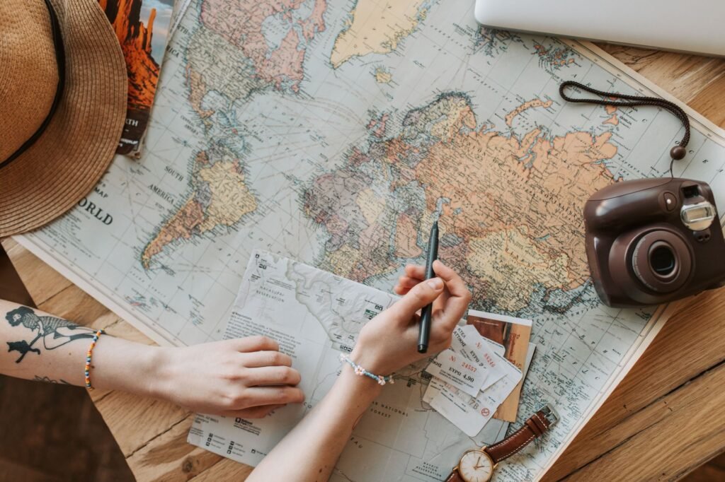 Notebook, phone and map on a desk used for planning travel arrangements
