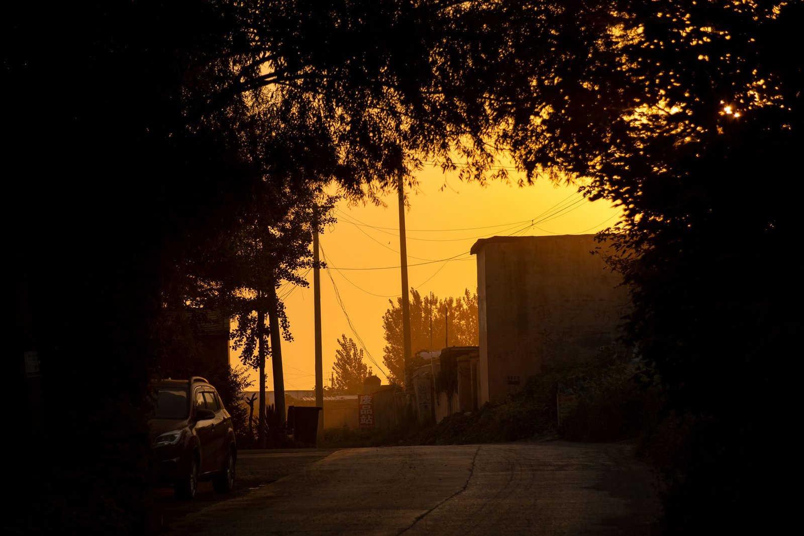 Quiet street in a small semi-rural Nigerian town at golden hour