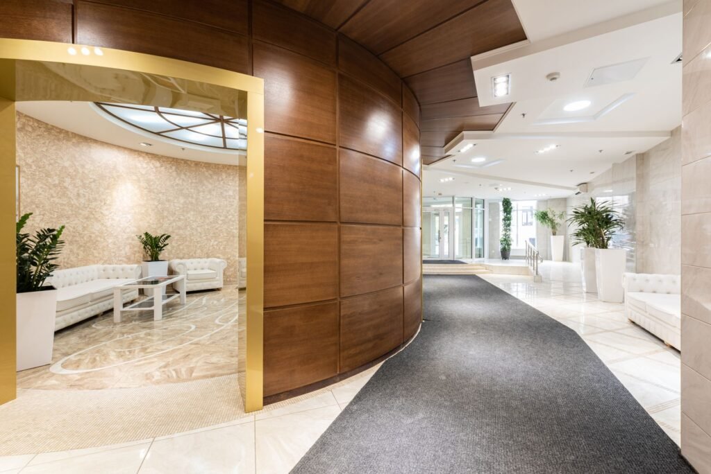 A modest hotel reception area in daylight used as a neutral meeting point